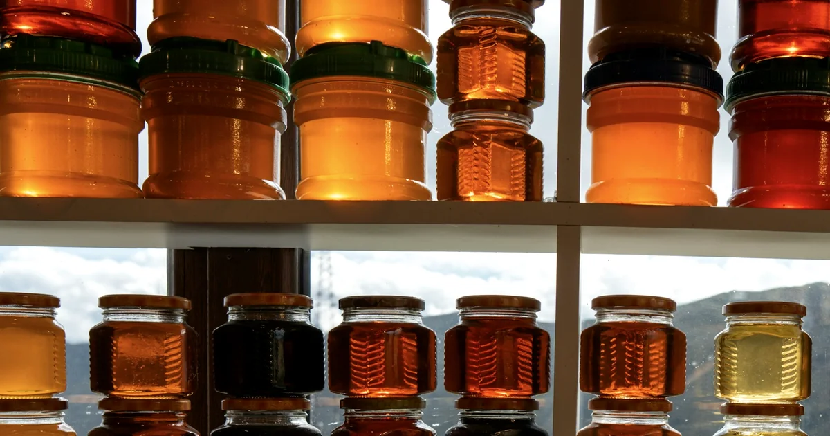 Étagères remplies de pots de miel ambrés
